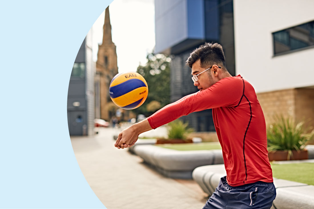 Student playing with volleyball