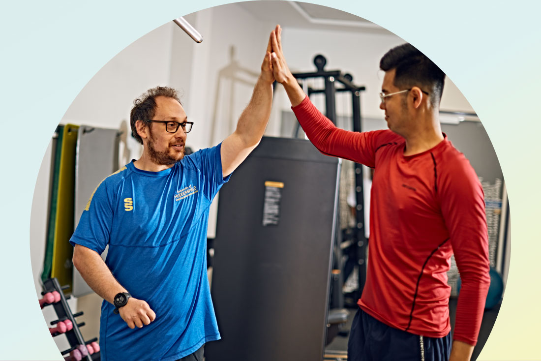 trainer and person high fiving