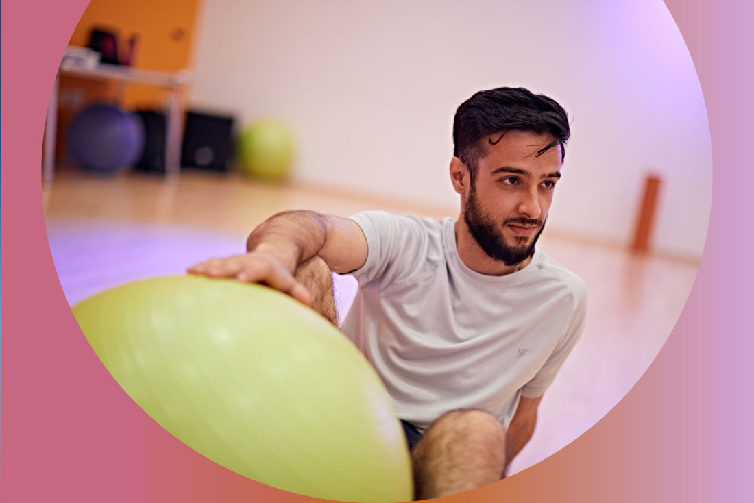 Student holding pilates ball