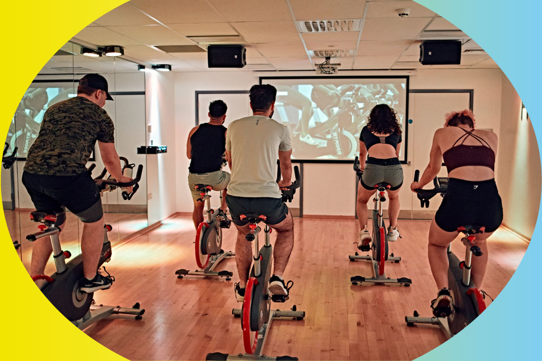 People exercising in a virtual spinning class