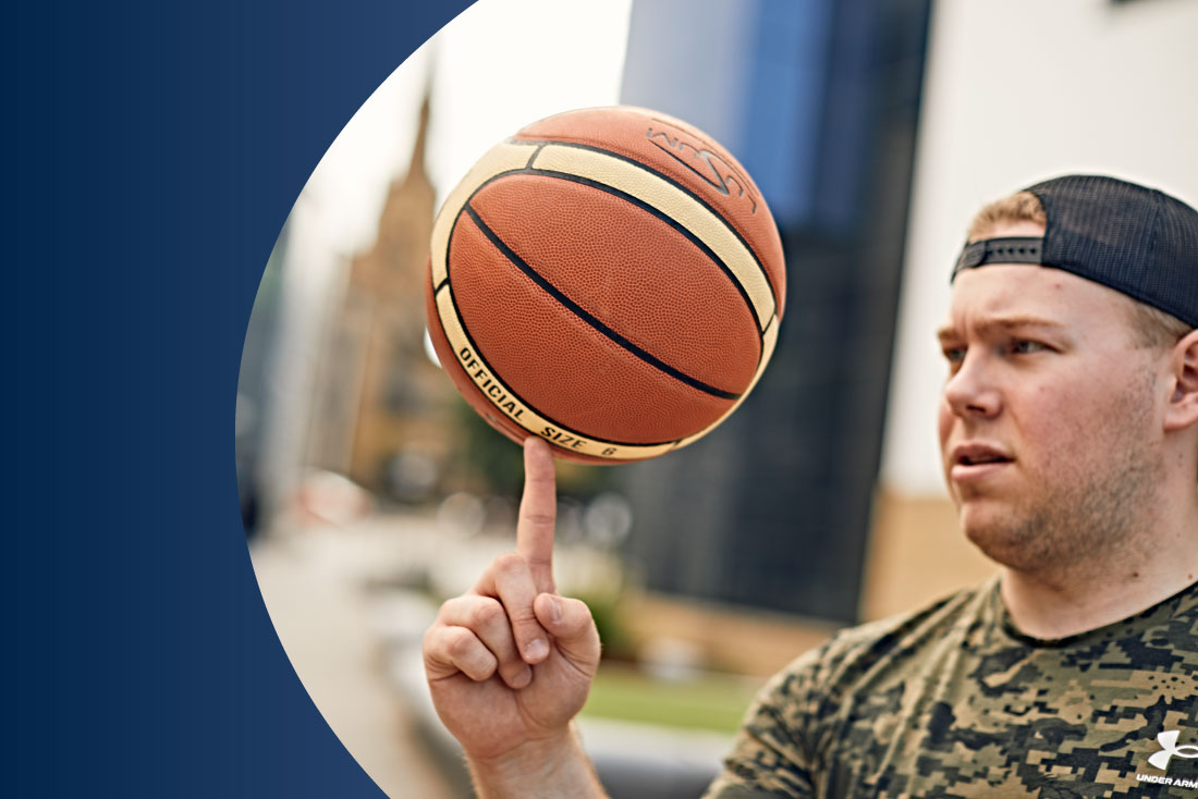 Student playing with basketball