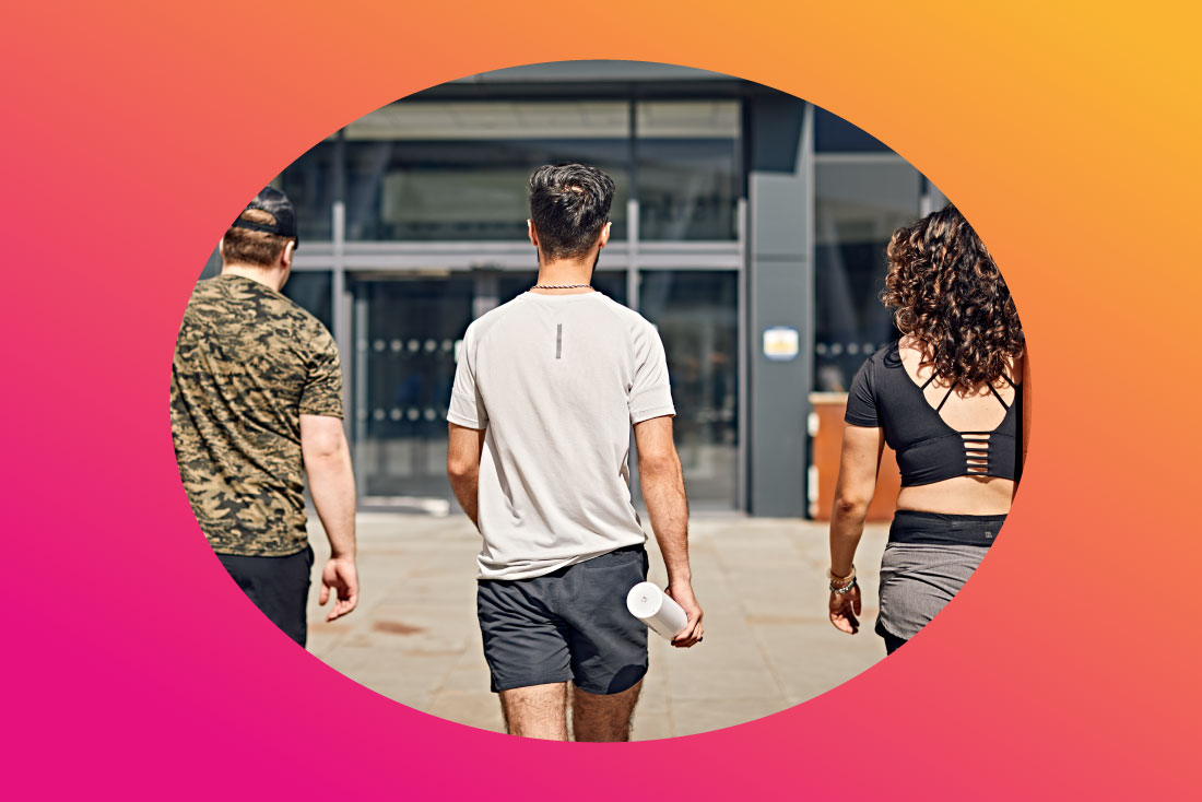 Three students walking in gym clothing